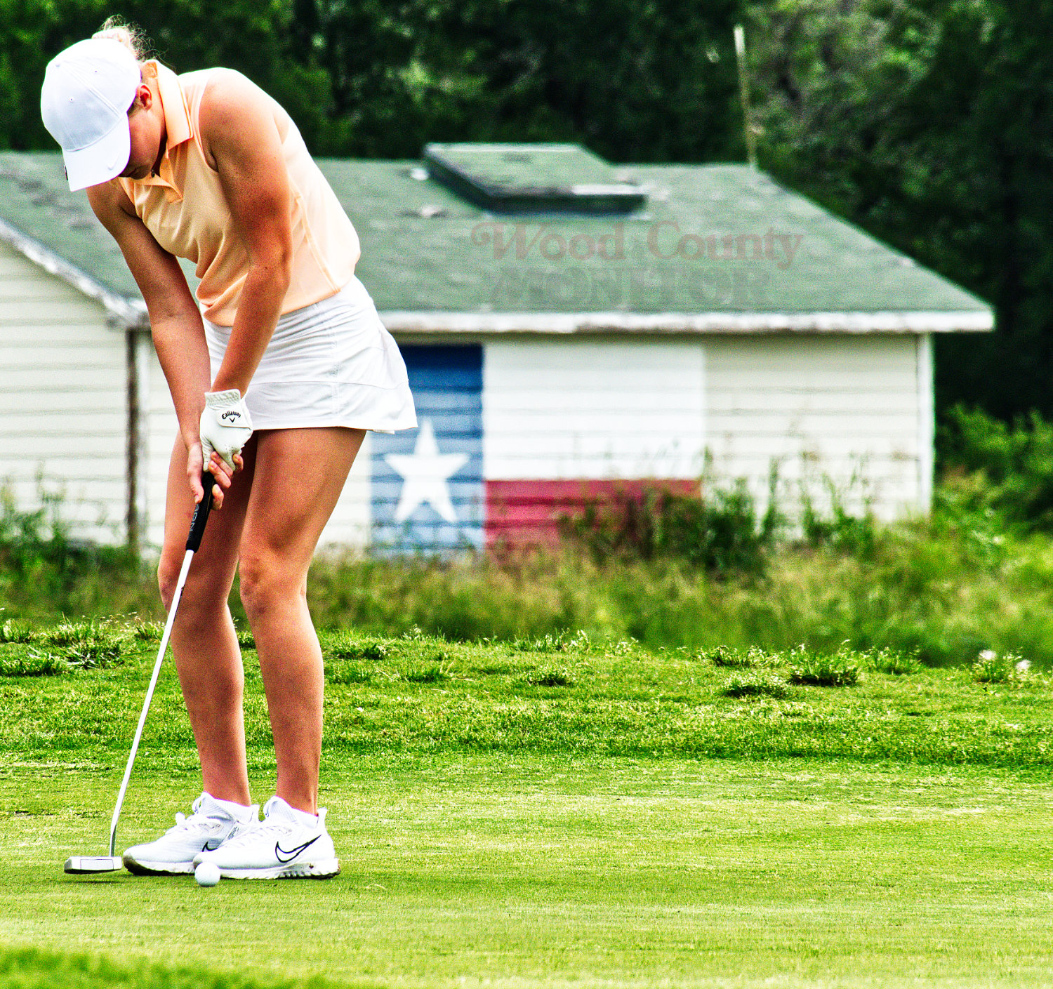 Ava Johnson taps in a short putt on the par-four 7th in the middle of her first round Monday in Manor. [see more shots from state]